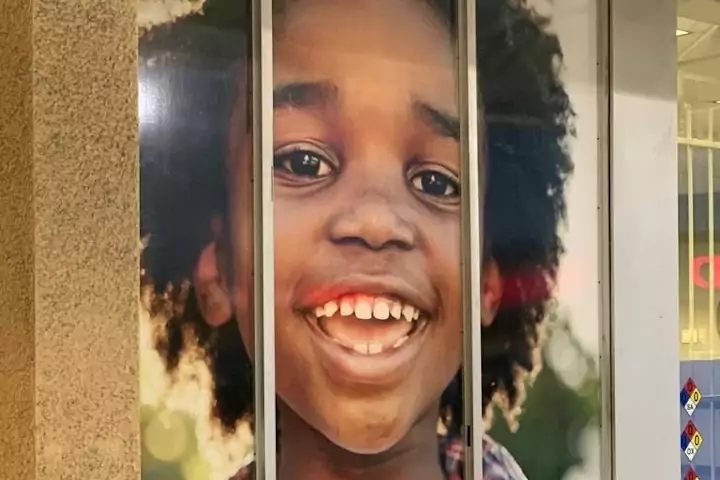 Oracle Signs Texas - Photo of a window stick-on ad featuring a smiling boy